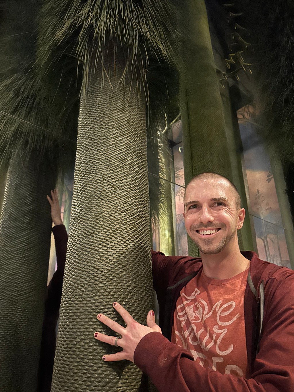 Frank Brown Cloud beside a model of a scale tree.